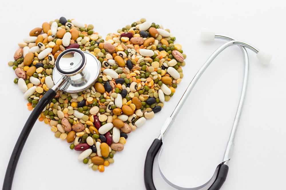a heart made out of legumes, next to a stethoscope 